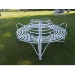 A wrought iron strapwork tree seat