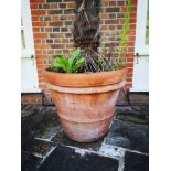 A pair of tapering cylindrical terracotta planters