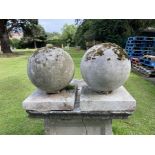 A pair of composition stone gate pier balls