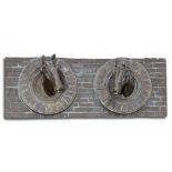 A bronzed fibreglass wall plaque of two horse's heads
