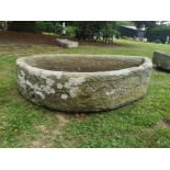 A D-shaped carved stone trough