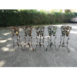 A set of three wrought iron jardiniere stands