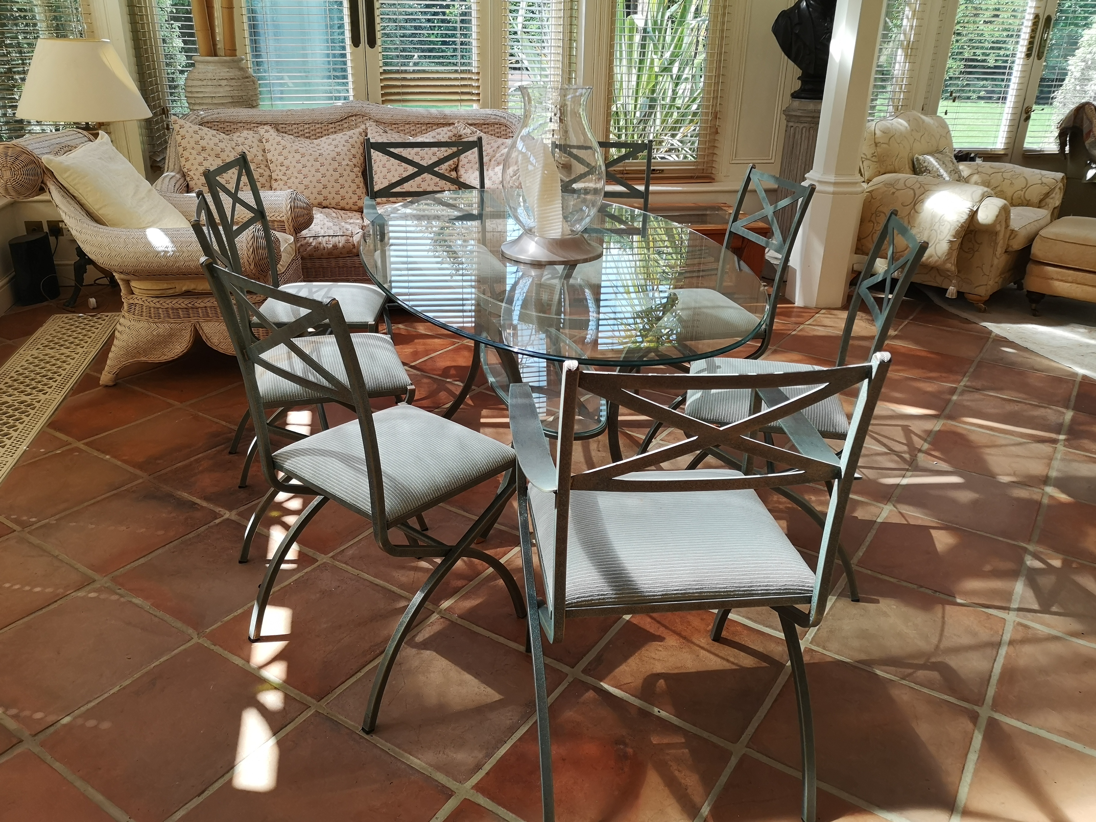 A suite of painted metal dining room furniture