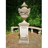 A composition stone finial on pedestal