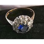 9ct gold 375 blue stone centre surrounded by 10 small white stones set in white gold size P