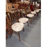 A set of 4 +2 Ercol dining chairs with original stickers attached