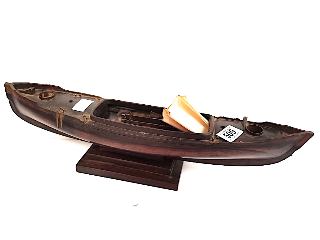 A rosewood 50cm long Model of a sailing canoe with letter from National Martime Museum