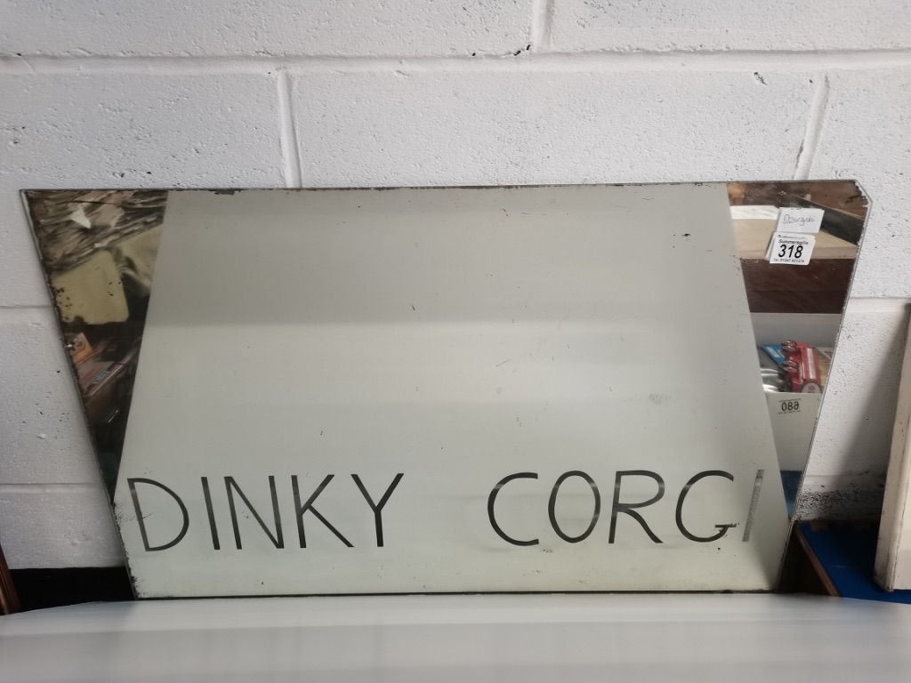 A vintage shop mirror engraved with Dinky & Corgi