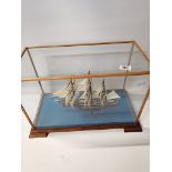 A small Model of Clipper Sailing Ship in Glass Case