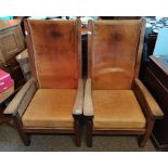 A pair of Mouseman oak smoking chairs with leather seats
