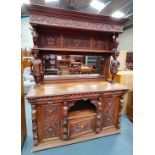 An Antique Large Heavily Carved Dutch Style sideboard with mirror back. Fabulous carved figurines.