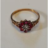 9ct gold ring 8 red stones with centre stone in white pierced shoulders size M