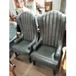 Pair of grey leather high backed arm chairs with pleated fabric backs