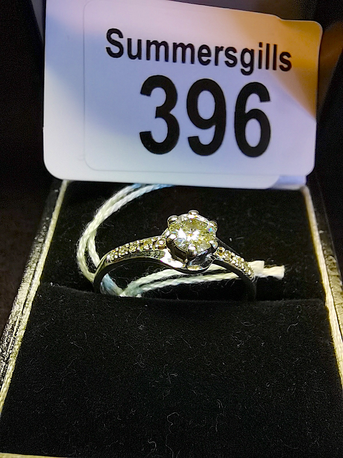 White diamond solitaire with diamond shoulders in 9ct white gold