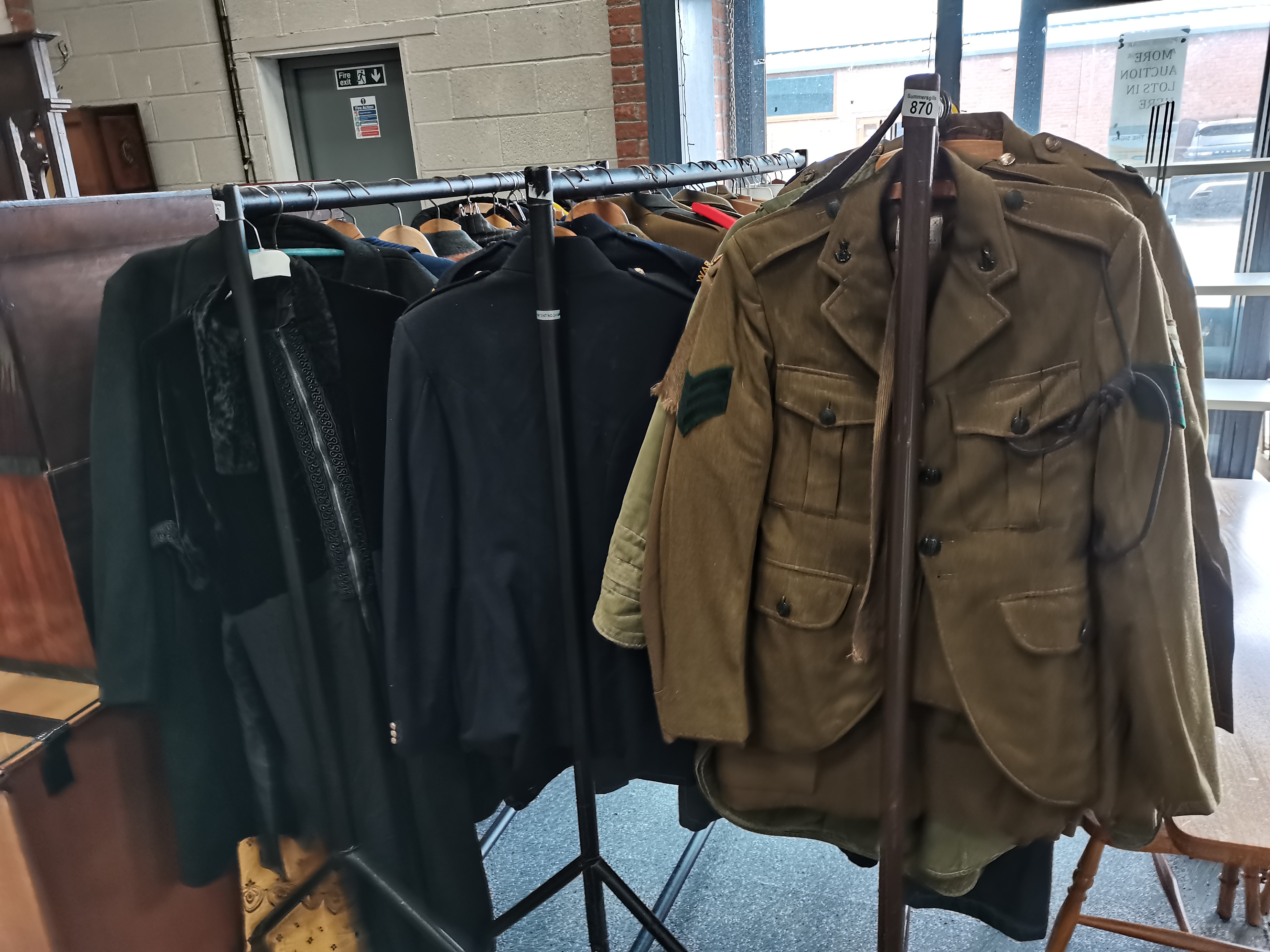 large collection of old military uniforms, fur coats etc