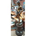 A 6ft bronze statue of David and Goliath after the fight on an oak Victorian carved stand