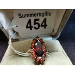 9ct yellow gold ring Size P 4ct red centre sphinx shape stone with basket of 15 red stones