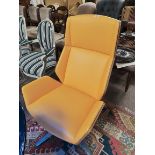 An Eames style armchair in bright yellow and wood made by BOSS