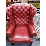 Red leather wing back arm chair