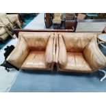 Retro style pair of tan leather chairs