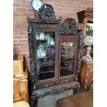 Antique Chinese heavily carved sisplay cabinet with dragons and leaves internally and externally