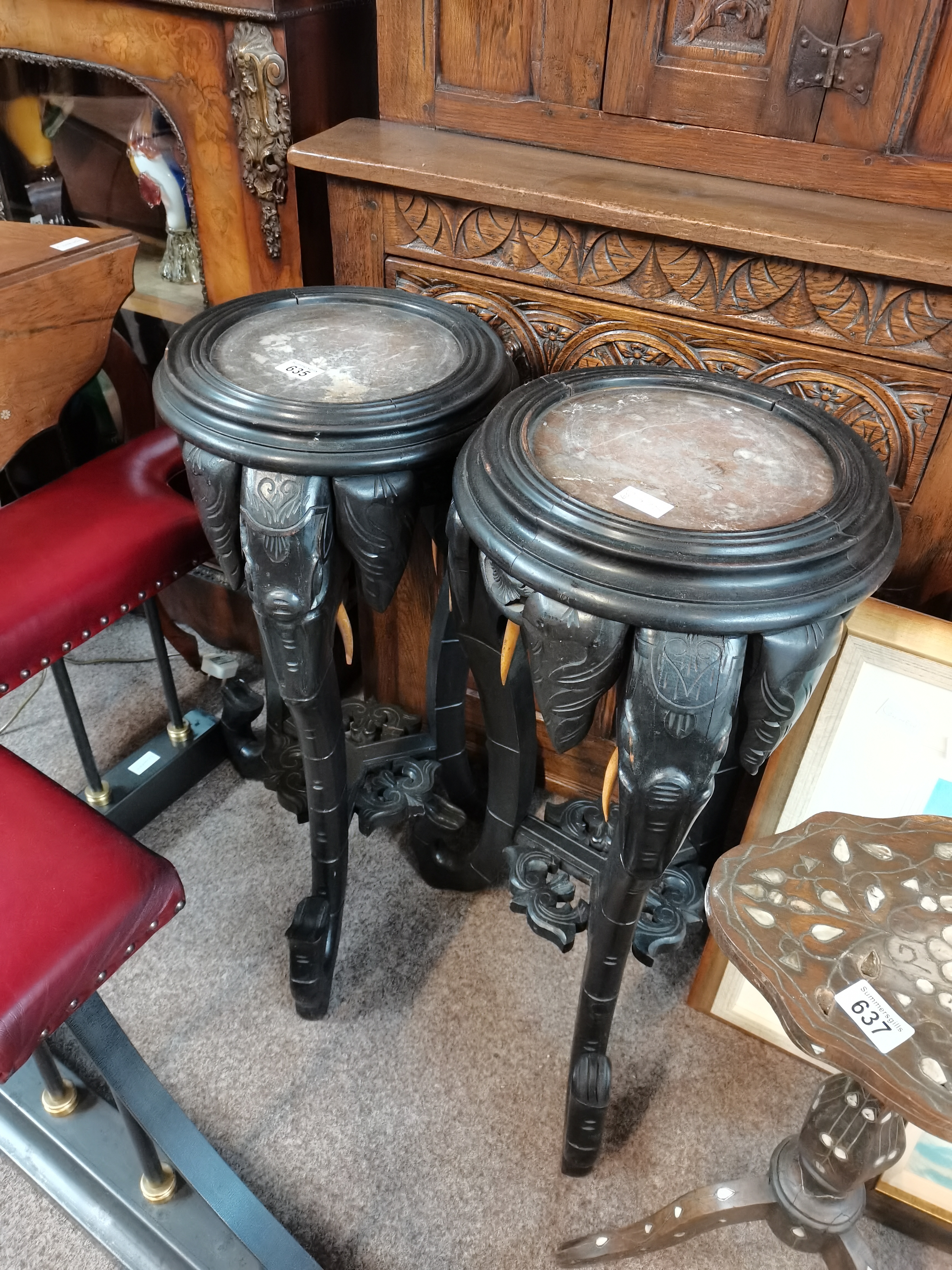 Pair of Antique plant stands heavily carved with elephants and marble topped