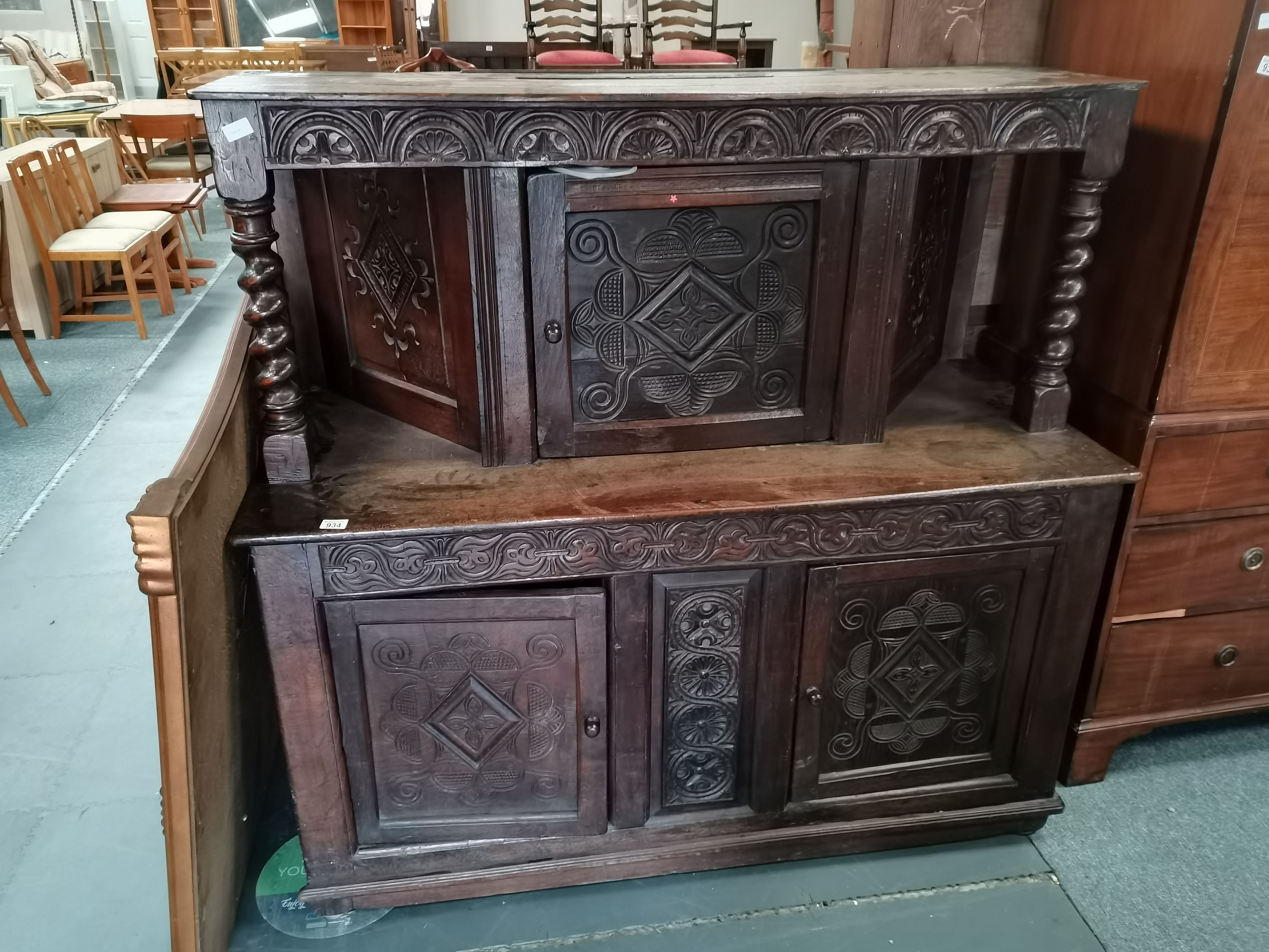 Early oak carved court cupboard with twisted supports and carved doors