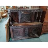 Early oak carved court cupboard with twisted supports and carved doors