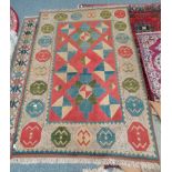 Red, Blue and cream faded rug 250 x 155