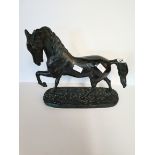 Bronze effect horse on stand