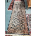 India Black and faded orage rug. 292 x 96. Contition fair air rose coloured male carpet