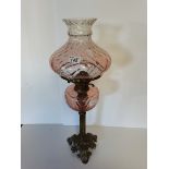 Pink glass and brass oil lamp