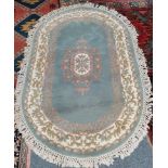 Green and cream oval rug