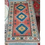 Faded red and blue rug condition worn 220 x 130
