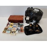 Ebony elephephant, cigaretete cards and binoculars