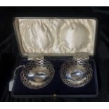 A CASED PAIR OF HALLMARKED SILVER BOWLS With pierced fretwork rims.