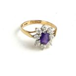 A VINTAGE 9CT GOLD AMETHYST AND PASTE SET RING The single oval amethyst set with paste stones