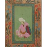 A PERSIAN MUGHAL WATERCOLOUR PORTRAIT Seated gent wearing traditional attire and elaborate floral