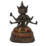 A TIBETAN GILT BRONZE THREE HEAD SADGSDGG BUDDHA FIGURE Having three heads and eight arms, on a