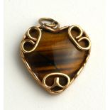 A VINTAGE 9CT GOLD AND TIGER'S EYE PENDANT NECKLACE The heart form stone in a plain 9ct gold