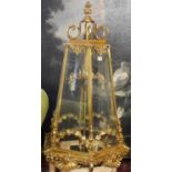 A LARGE POLISHED BRASS LANTERN The hexagonal tapering etched glazed panels above swags, shells and