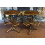 A PAIR OF VICTORIAN WALNUT BOOK TABLES The circular tops above revolving galleried book troughs,