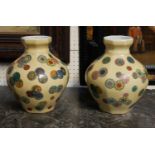 A PAIR OF CHINESE PORCELAIN 'FLOWER MOTIF' VASES Decorated with floral roundels, Buddhist symbols