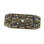 AN ART DECO YELLOW METAL, DIAMOND AND SAPPHIRE BROOCH The central round cut diamond in a pavé set