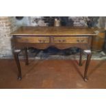 AN EARLY 20TH CENTURY OAK SIDE TABLE With two drawers, raised on cabriole legs. (107cm x 49cm x