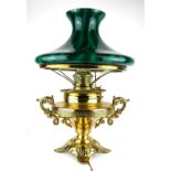 A LATE 19TH/EARLY 20TH CENTURY BRASS AND GREEN GLASS TABLE LAMP Having a circular green glass shade,