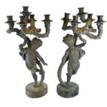 A PAIR OF 19TH CENTURY BRONZE FIGURAL FIVE BRANCH CANDELABRA With putti holding candles aloft, on