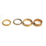 A COLLECTION OF FOUR VINTAGE GOLD WEDDING BANDS Comprising a 22ct gold band with engraved decoration