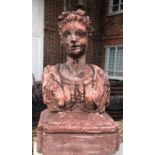 A HALF LIFE SIZE RED CLAY BUST OF A ROMAN FEMALE On a stepped base. (63cm)