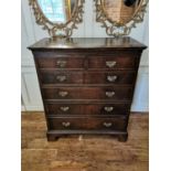 A MID 18TH CENTURY SOLID OAK CHEST Of two short above four long graduated drawers, raised on bracket